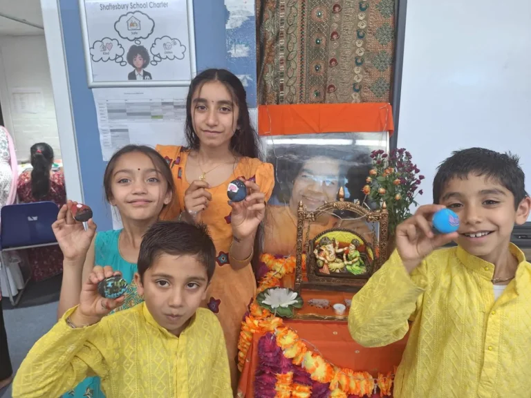 Children showing their painted stones in the kids' zone