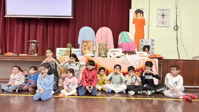 Younger pupils seated in front of the Ram Navami display