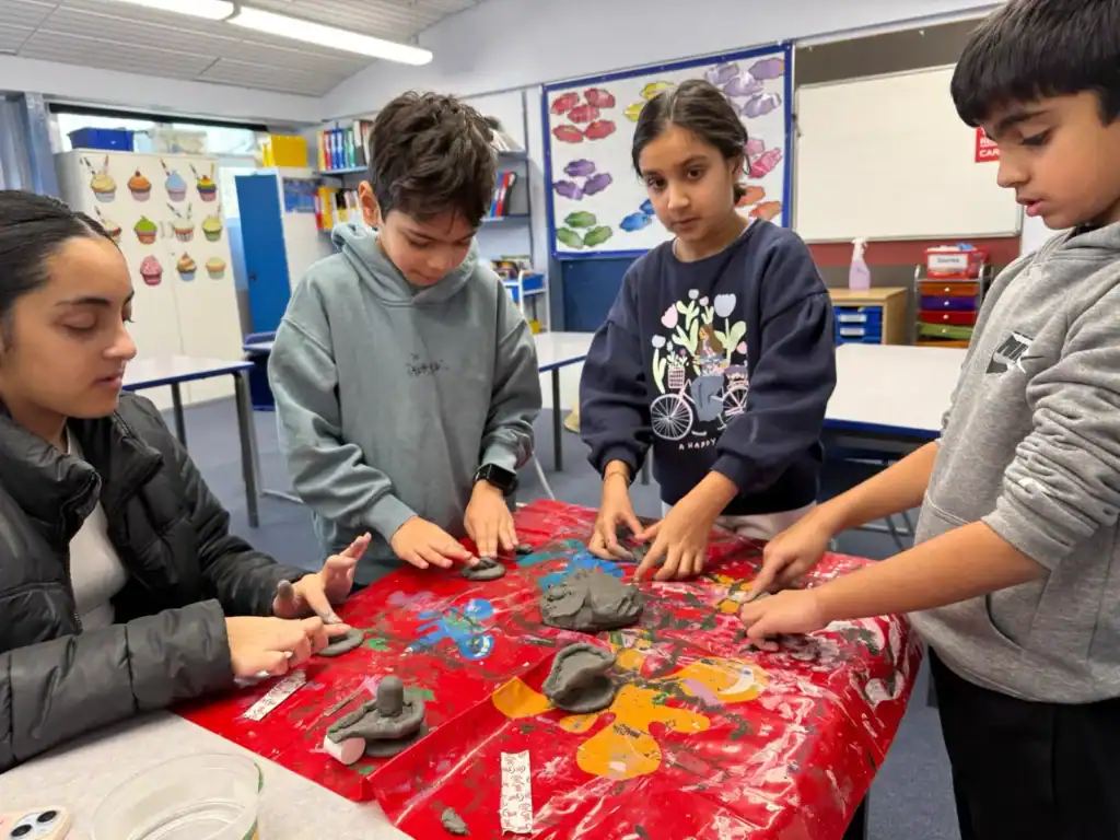 Pupils shaping clay for Maha Shivratri