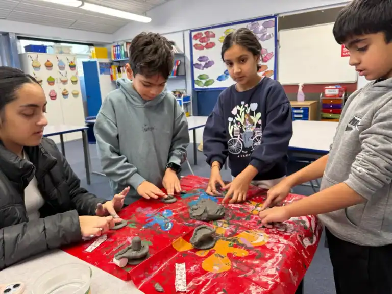 Pupils shaping clay Shiv lingams for Maha Shivratri